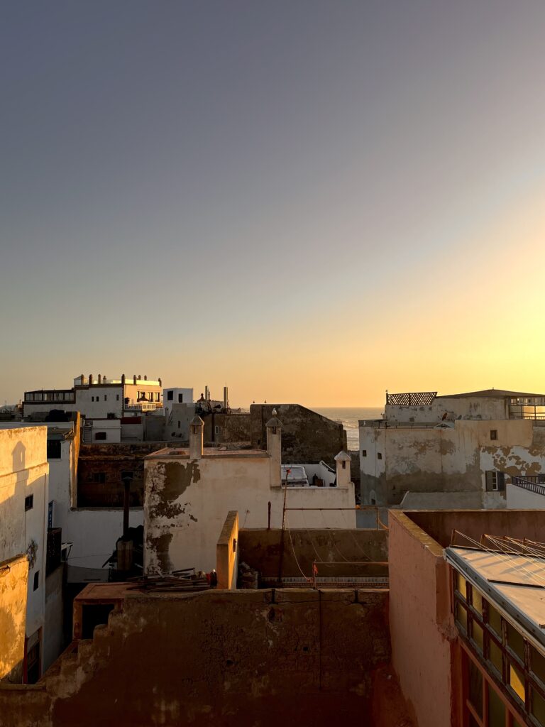 sunset view over roofs and the sea