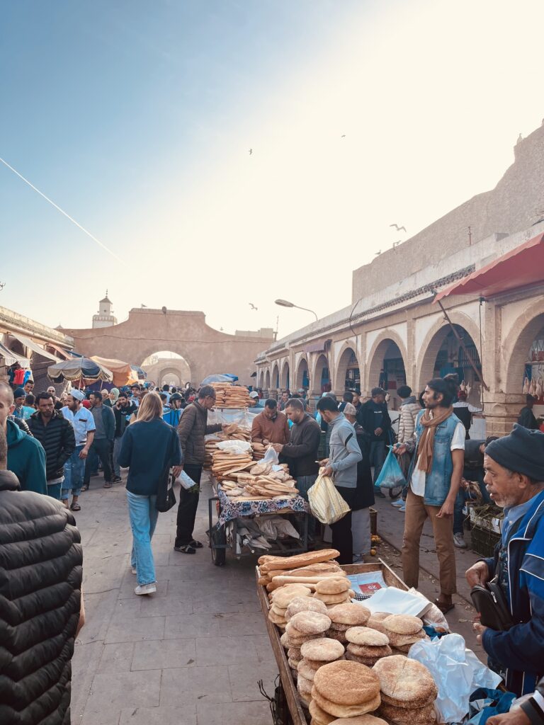 market scene in Essaouira; men selling flat bread